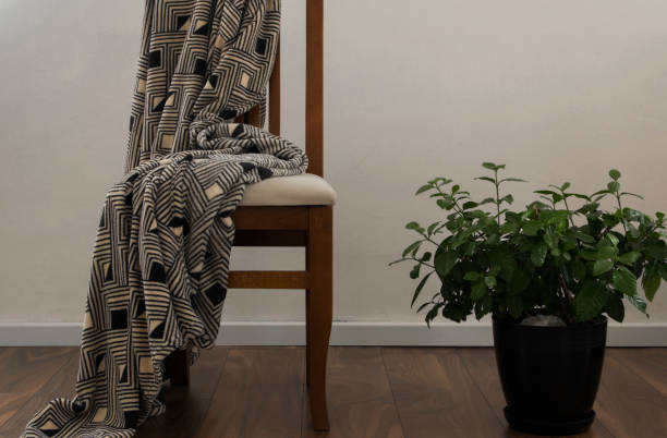 Merino wool throw draped over a reading chair